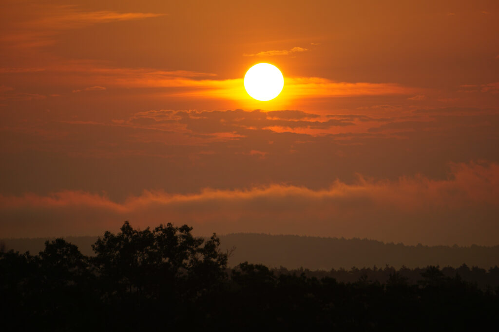 a beautiful sunset with the sun sinking below the horizon